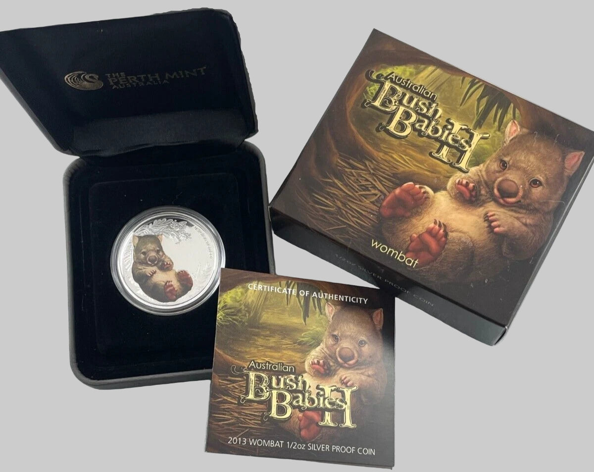 Silver coin with packaging and certificate of authenticity on a light gray surface